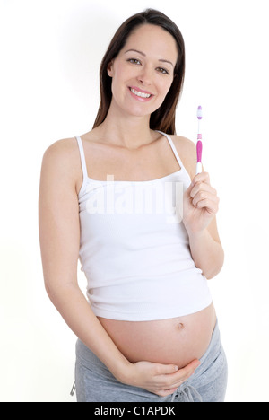 Pregnant woman holding toothbrush Stock Photo