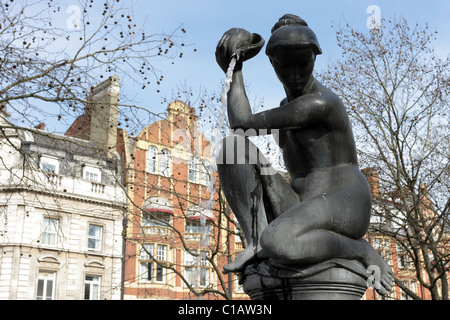 The goddess Venus Fountain in Sloane Square, revealed here is the upper portion of the fountain. Stock Photo