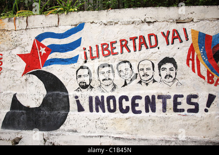 Graffiti depicting the 5 Cuban Heroes on a wall in Cuba Stock Photo