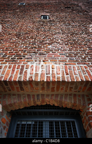 Brick building with steel bars in windows Stock Photo - Alamy