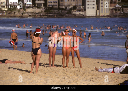 Happy band of beach go-ers getting their photographs taken on Bondi Beach, Australia Stock Photo