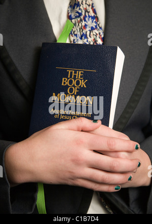 The Book of Mormon being held by a Mormon teenaged missionary Stock Photo