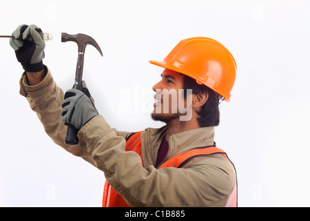 hard hat worker using a hammer Stock Photo