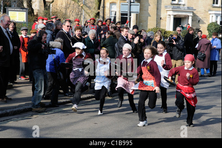 Olney Pancake race young girls competing in this annual event in Olney Buckinghamshire England 2011 Olney Middle school pupils Stock Photo