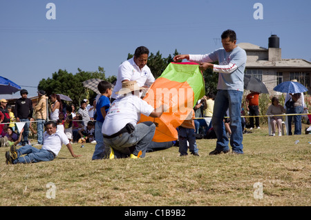 Persons inflating a Globo de Cantolla (hot air paper balloon) in San Agustin Ohtenco, Mexico Stock Photo