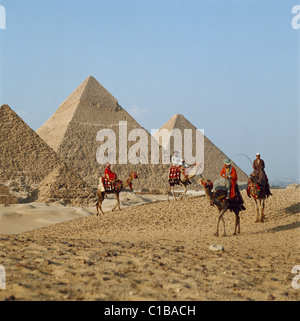 Camels riders in front of the Pyramids, Giza, Cairo, Egypt, North Africa Stock Photo