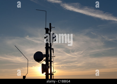Cell Phone Antenna Mast On Rooftop Stock Photo