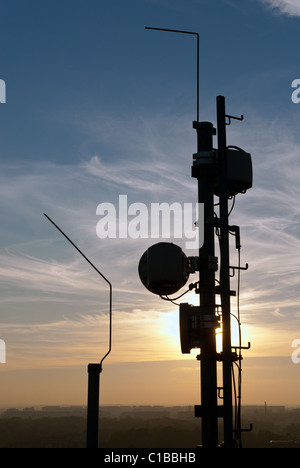 Cell Phone Antenna Mast On Rooftop Stock Photo