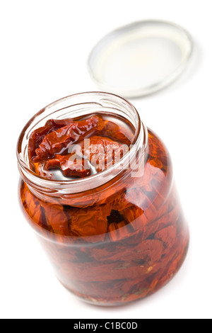 dried tomatoes in glass jar on white background Stock Photo