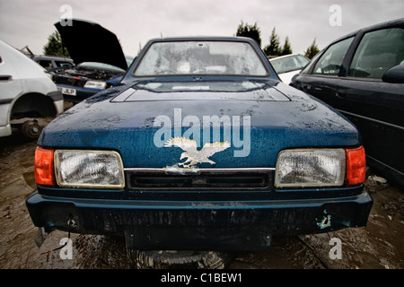 Old Reliant three wheeler in scrap yard Stock Photo