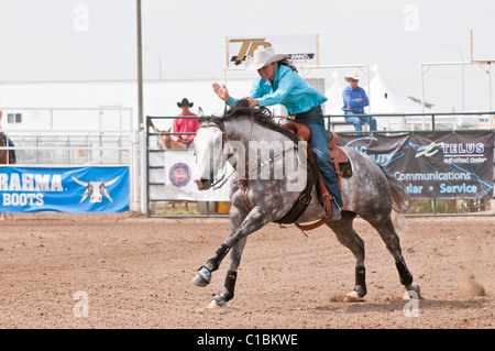 Cowgirl riding fast during barrel racing, Strathmore Heritage Days, Rodeo, Strathmore, Alberta, Canada Stock Photo