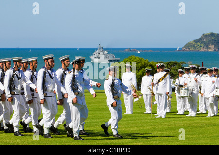 The navel vessel Te Kaha anchored whilst the Royal New Zealand Navy perform a beating retreat sunset ceremony Stock Photo
