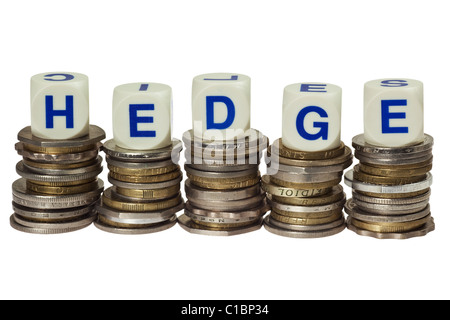 Stacks of coins with the word HEDGE isolated on white background Stock Photo