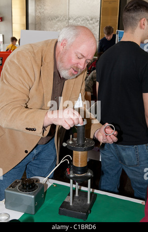 Professor demonstrating magnetism and electromagnetism Stock Photo