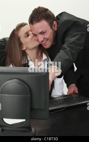 Young office colleagues having fun in front of an office computer. Stock Photo