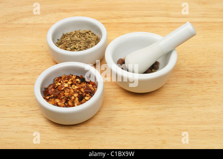 Spices in a ramekins and a pestle and mortar Stock Photo