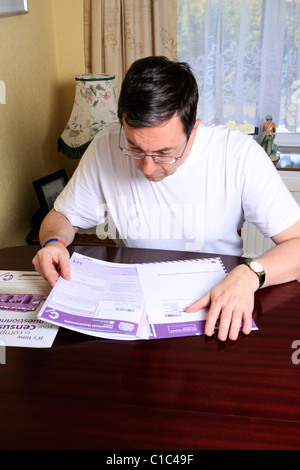 Adult male completing the compulsory 2011 UK Census questionnaire Stock Photo