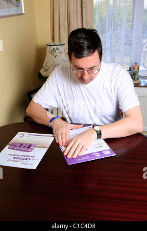 Adult male completing the compulsory UK Census questionnaire Stock Photo