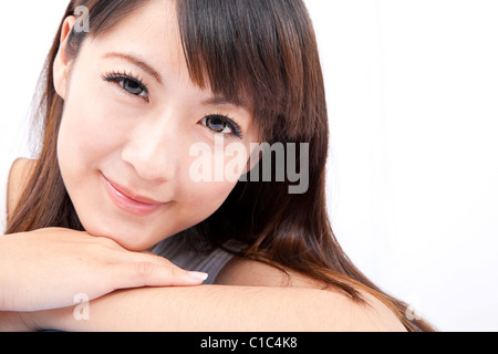 Closeup portrait of a smiling young asian woman isolated on white background Stock Photo
