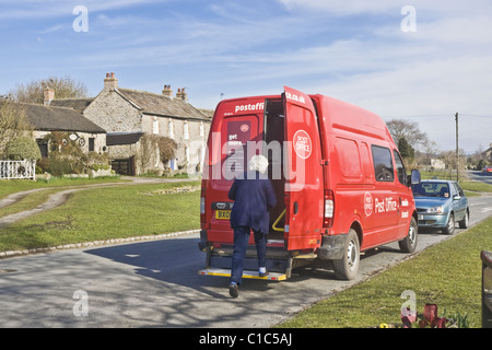 The mobile Post Office on one of its twice weekly visits to Bellerby in North Yorkshire.  The van stays for one hour per visit. Stock Photo