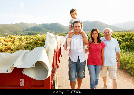 Generational family walking in vineyard Stock Photo