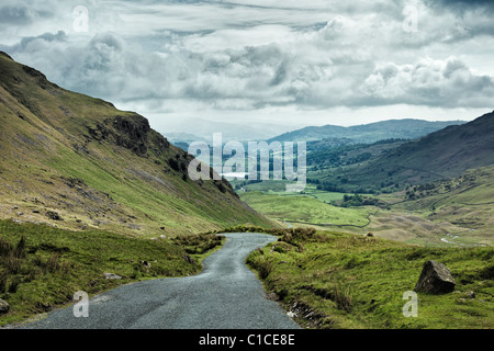 Wrynose Pass in Lake District UK with mountain road looking towards Little Langdale Tarn Stock Photo