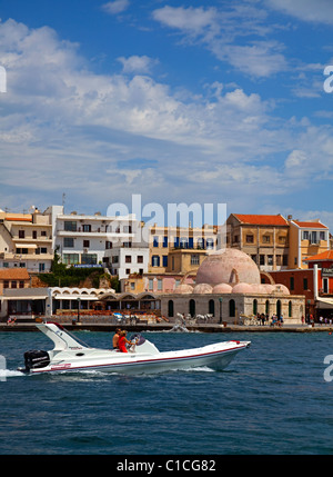 Chania Harbour Crete Greece small yacht sailing with male and female onboard Stock Photo