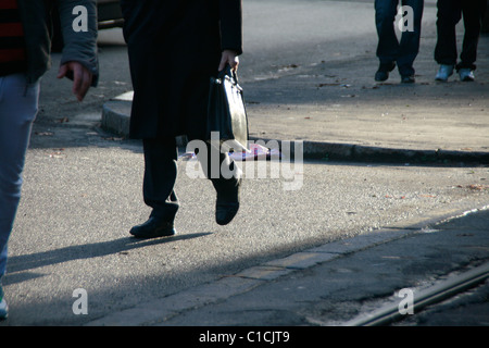 commuter business man commuter with briefcase case  feet legs walking  in street in town Stock Photo