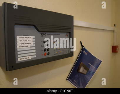 Fire alarm panel and fire alarm callpoint in communal housing block ready and working Stock Photo