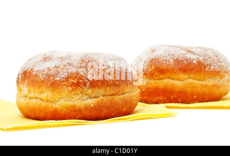 two donuts in powdered sugar on paper napkins Stock Photo