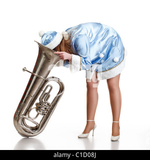 funny santa girl stuck head in big trumpet Stock Photo