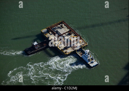 aerial view above tugboats holding construction barge in position San Francisco Bay Bridge project California Stock Photo