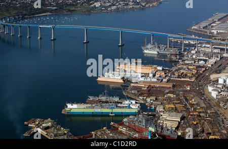 aerial view above General Dynamics NASSCO ship construction yard Port of San Diego and Coronado Bridge California Stock Photo