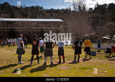 Big burly men watching one of their competitors throw the hammer at the Sonora California Celtic Faire Stock Photo