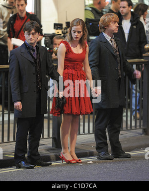 Daniel Radcliffe, Emma Watson and Rupert Grint bring the West End to a standstill as they film scenes for the last movie in the Stock Photo