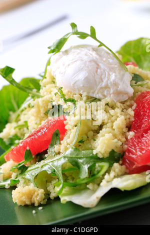 Couscous with red orange and rocket, poached egg on top Stock Photo