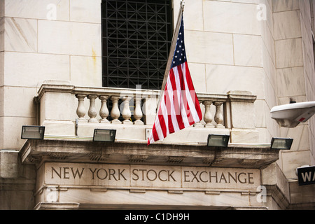 Outside the New York Stock Exchange with the American Stars and Stripes flag flying. Stock Photo