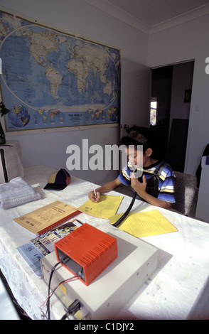 Australia, Northern Territory, Red Center, School of the air, young people working their courses in residence, by radio Stock Photo