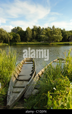Two old wooden long-boats found at the lake shore in Lublin Heritage Park Stock Photo