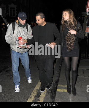 American magician David Blaine walking through Soho with his girlfriend. A beggar accosted the couple and asked for some spare Stock Photo