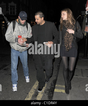 American magician David Blaine walking through Soho with his girlfriend. A beggar accosted the couple and asked for some spare Stock Photo