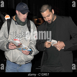 American magician David Blaine walking through Soho with his girlfriend. A beggar accosted the couple and asked for some spare Stock Photo