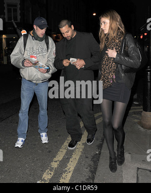 American magician David Blaine walking through Soho with his girlfriend. A beggar accosted the couple and asked for some spare Stock Photo