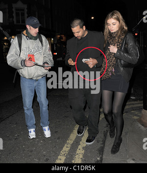 American magician David Blaine walking through Soho with his girlfriend. A beggar accosted the couple and asked for some spare Stock Photo