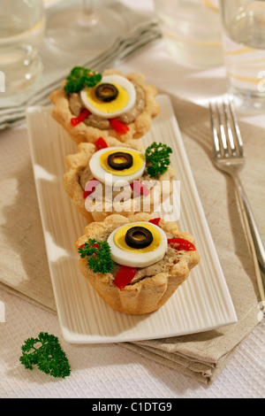 Tartlets with cheese and olives. Recipe available. Stock Photo