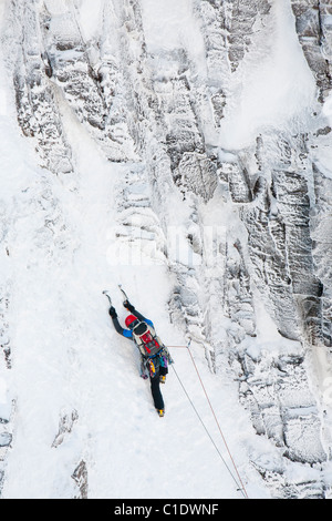 A mountaineer winter climbing in Coire an Sneachda in the Cairngorm mountains, Scotland, UK. Stock Photo