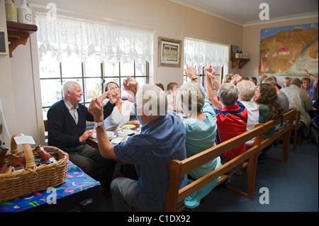 A tour group joining in at a singsong with Lazy Harry at the Billy Tea Rooms in Glenrowan, Victoria, Australia Stock Photo