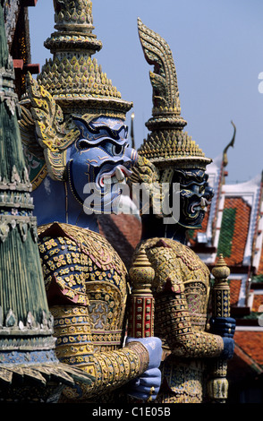 Thailand Bangkok Wat Phra Kaew Temple located in the Royal Palace enclosure monumental & phantasmagorical statues guarding doors Stock Photo