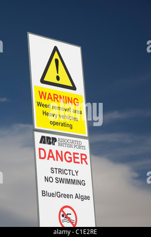 A warning sign about Blue Green Algae in Cavendish Dock in Barrow in Furness, Cumbria, UK. Stock Photo
