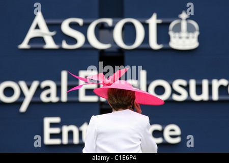 Woman in hat standing in front of the Royal Enclosure of the horse race track, Ascot, United Kingdom Stock Photo